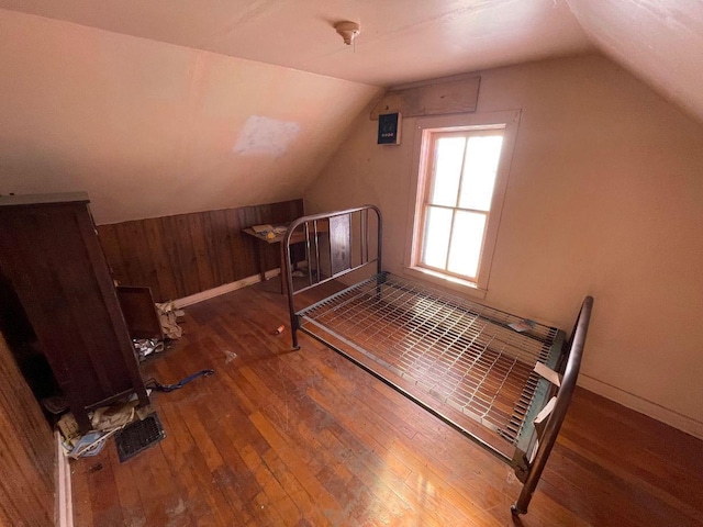 bedroom featuring lofted ceiling and dark hardwood / wood-style floors