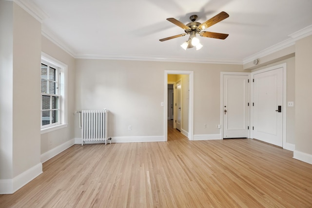 unfurnished room with crown molding, ceiling fan, radiator, and light hardwood / wood-style floors