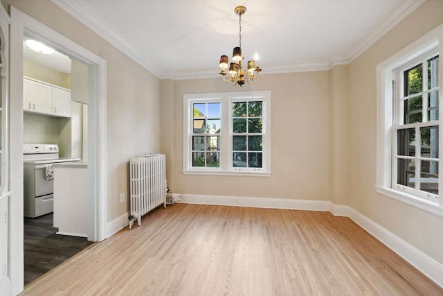 unfurnished dining area featuring hardwood / wood-style flooring, crown molding, radiator, and a chandelier