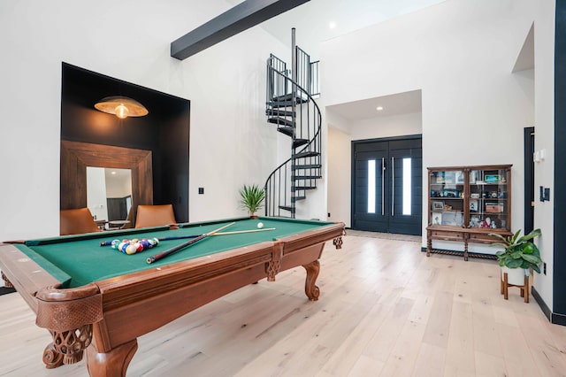 rec room with a towering ceiling, light hardwood / wood-style flooring, and pool table