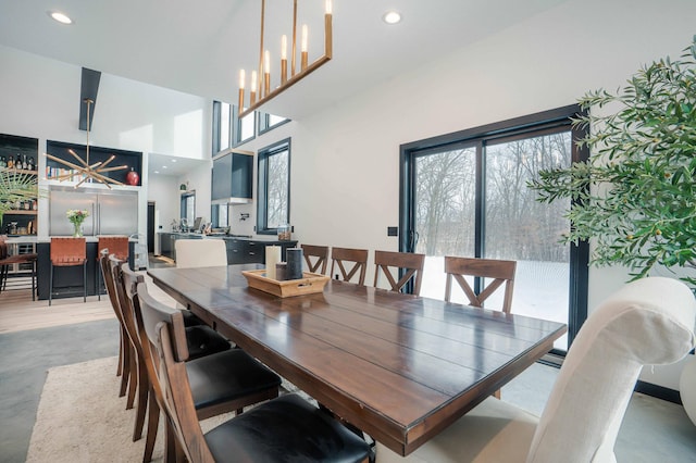 dining room with an inviting chandelier and a high ceiling