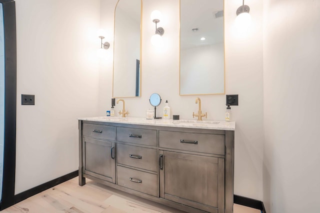 bathroom with vanity and hardwood / wood-style floors