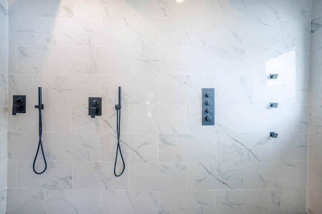 bathroom with tiled shower