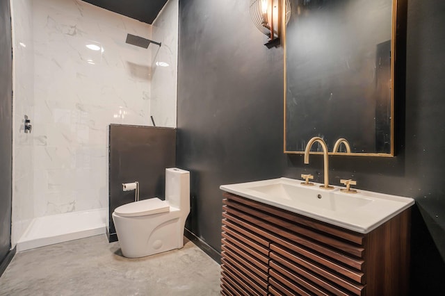 bathroom featuring vanity, a tile shower, and toilet