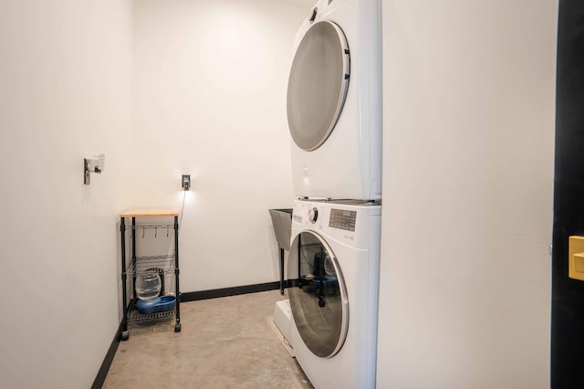 clothes washing area featuring stacked washer and dryer