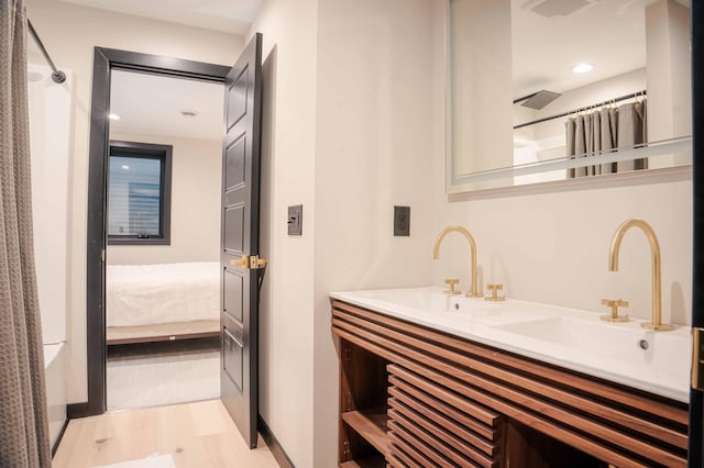 bathroom featuring vanity and hardwood / wood-style floors