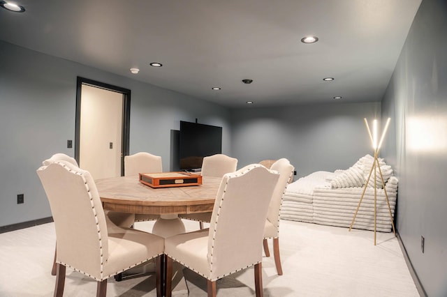 dining space featuring light colored carpet