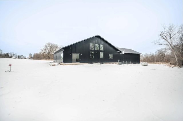 view of snow covered rear of property