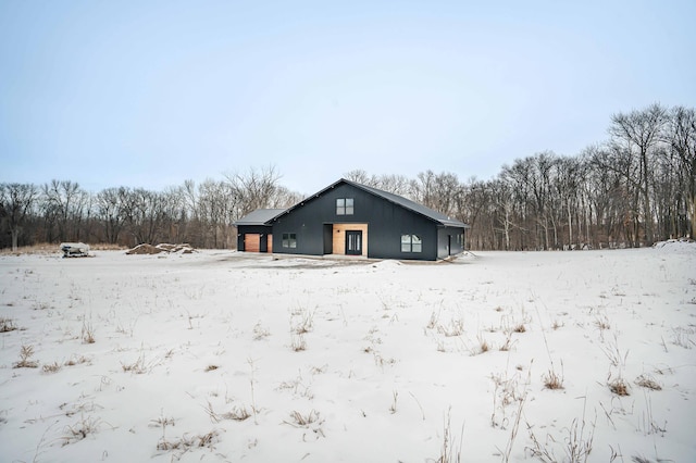 view of snow covered rear of property