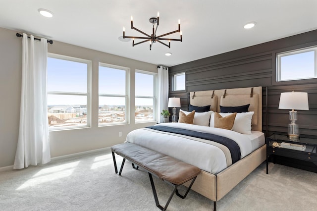 bedroom with light colored carpet and a chandelier