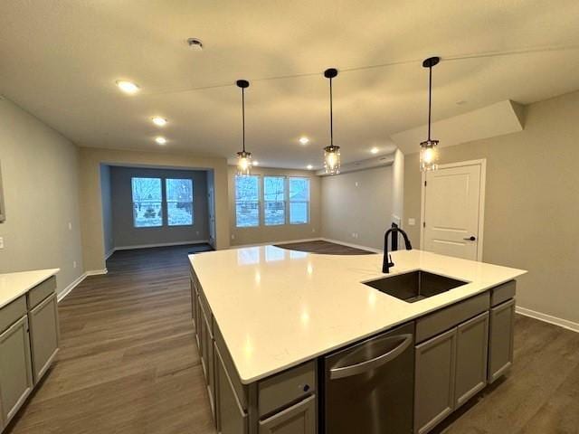 kitchen with a kitchen island with sink, dishwasher, sink, and gray cabinetry