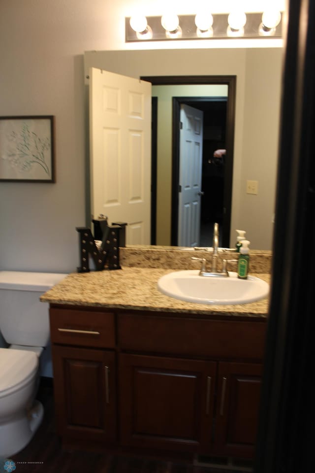 bathroom with vanity and toilet