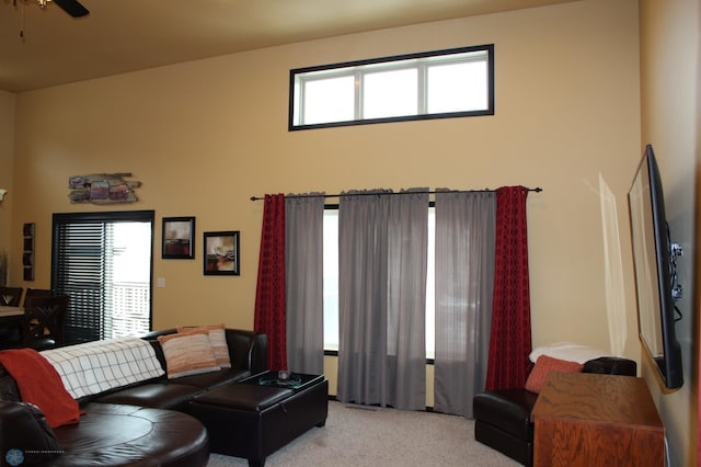 living room featuring ceiling fan and carpet