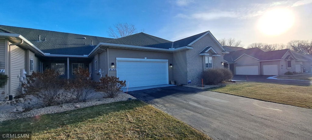 view of front of house featuring a garage and a yard