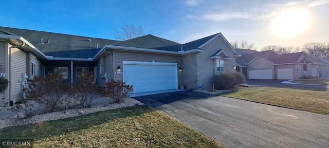 view of front of house featuring a garage and a yard