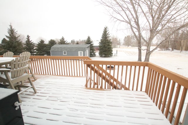 snow covered deck with an outdoor structure