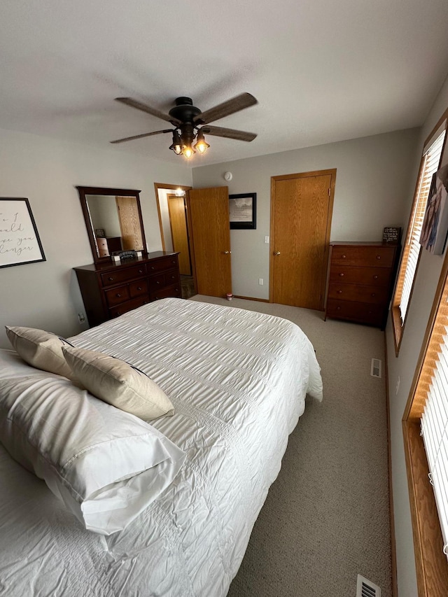 bedroom featuring ceiling fan and light colored carpet