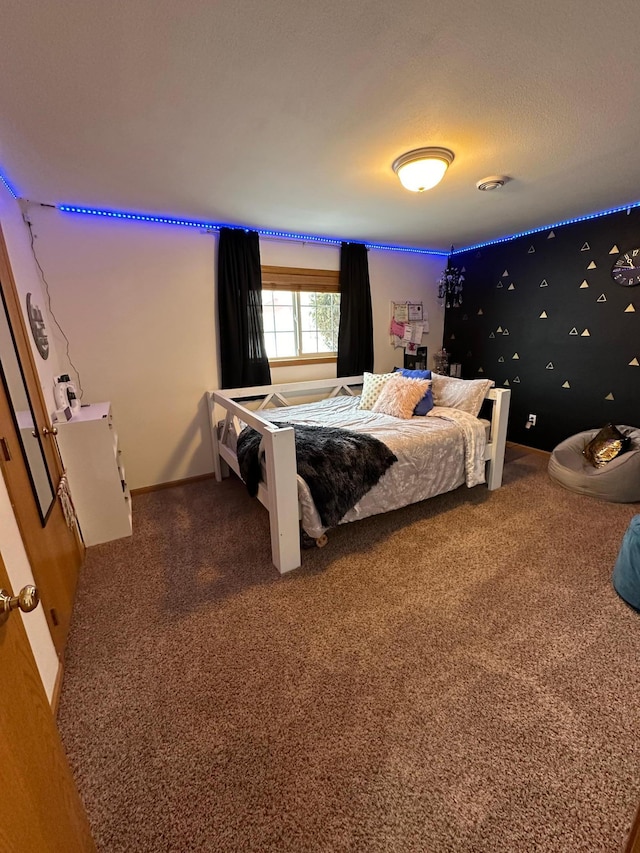 carpeted bedroom featuring a textured ceiling