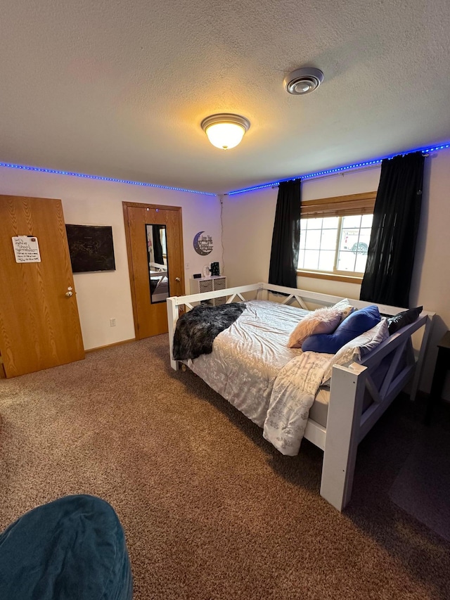 bedroom featuring carpet floors and a textured ceiling