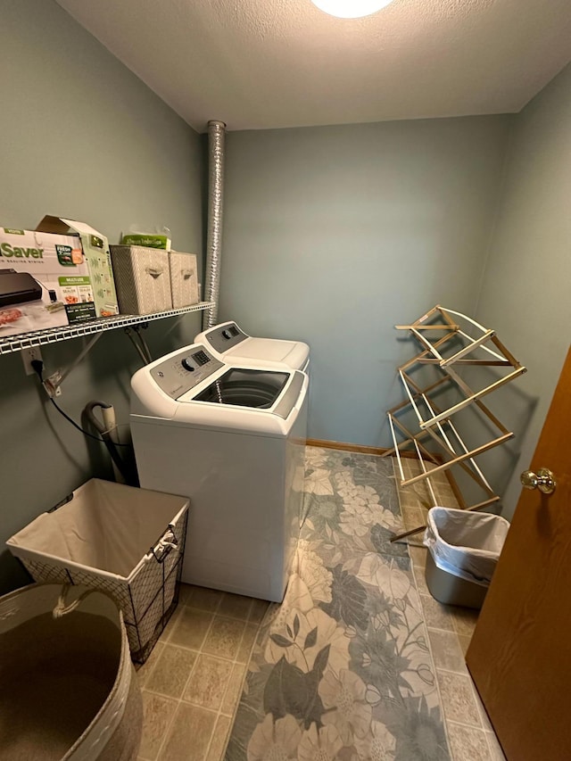 washroom with independent washer and dryer and a textured ceiling