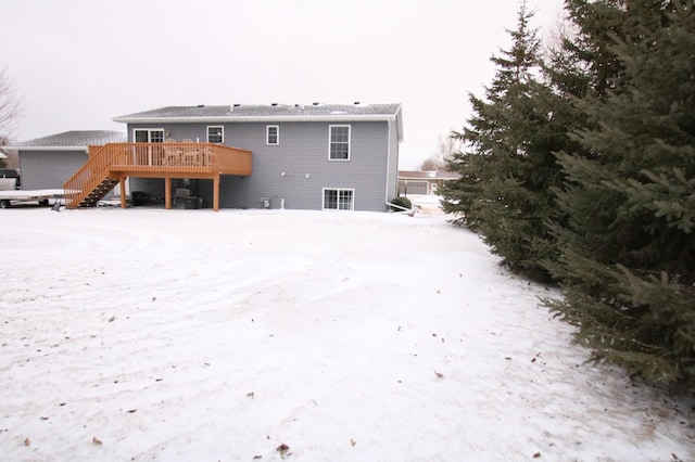 snow covered property featuring a wooden deck