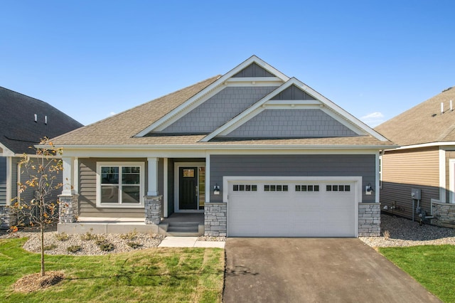 craftsman-style home with a garage and a front lawn