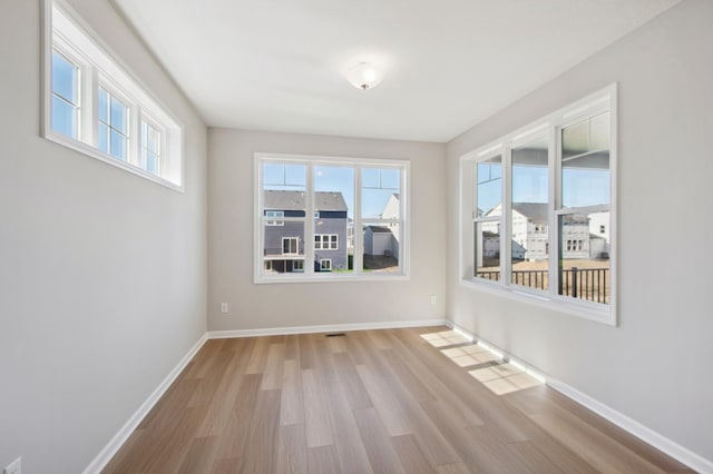 spare room with light hardwood / wood-style floors