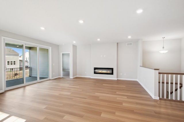 unfurnished living room with light hardwood / wood-style flooring