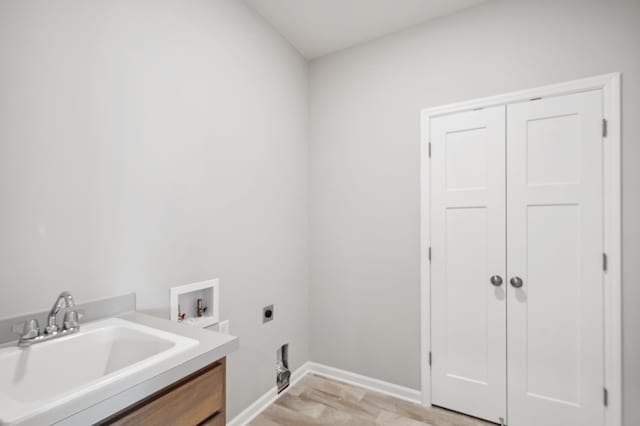 washroom with sink, hookup for an electric dryer, and hookup for a washing machine