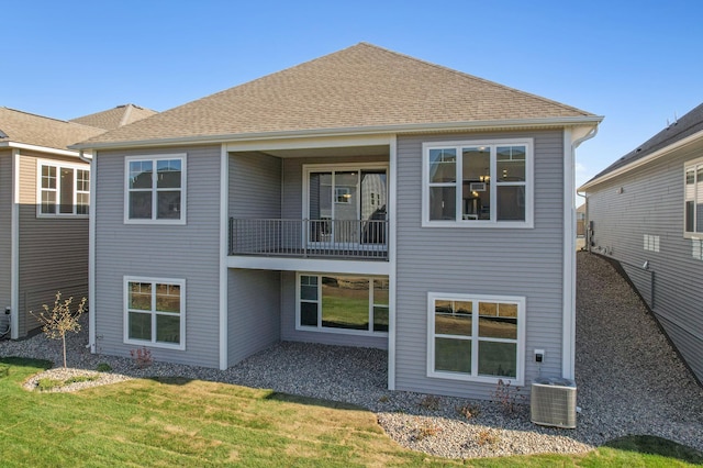 rear view of property with a yard and central AC unit