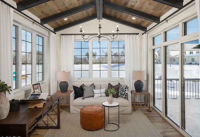 sunroom with a notable chandelier, wood ceiling, and vaulted ceiling with beams