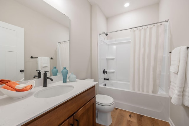 full bathroom with wood-type flooring, toilet, vanity, and shower / bath combo with shower curtain