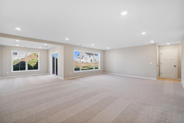 unfurnished living room with plenty of natural light and light colored carpet