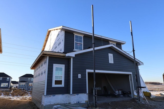 rear view of house with a garage