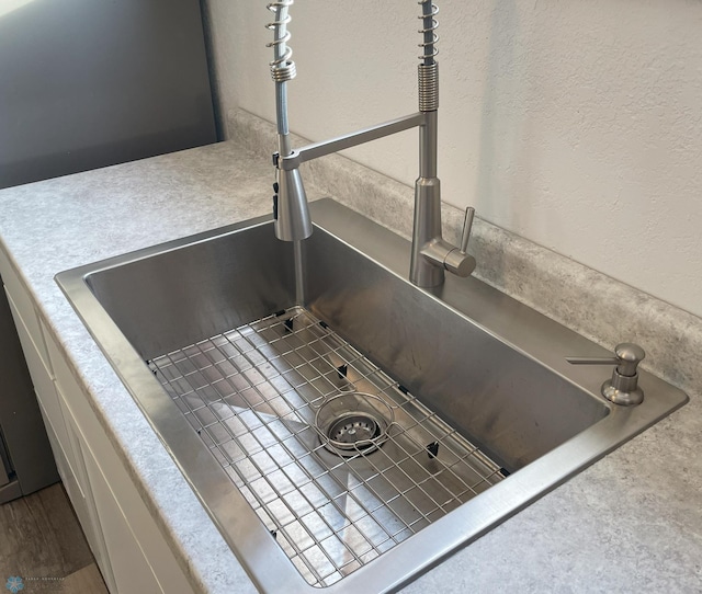 interior details featuring hardwood / wood-style flooring and sink