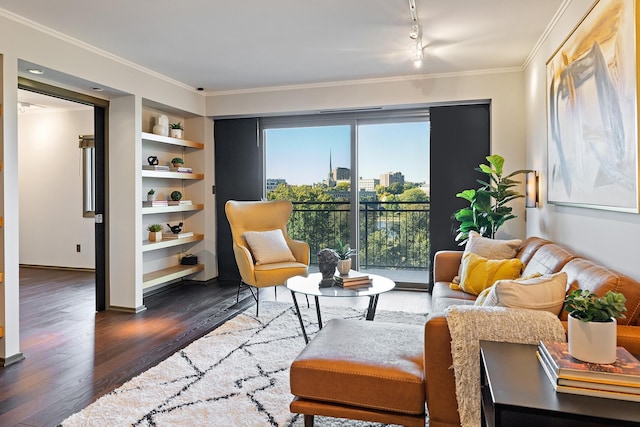 sitting room featuring crown molding, built in features, and dark hardwood / wood-style floors