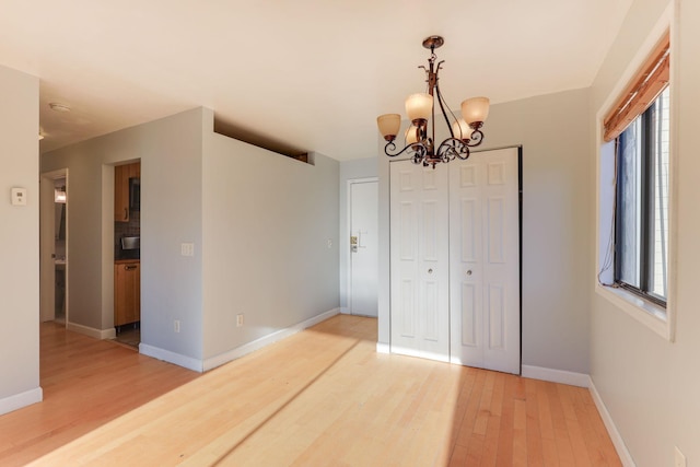 interior space with hardwood / wood-style floors and a notable chandelier