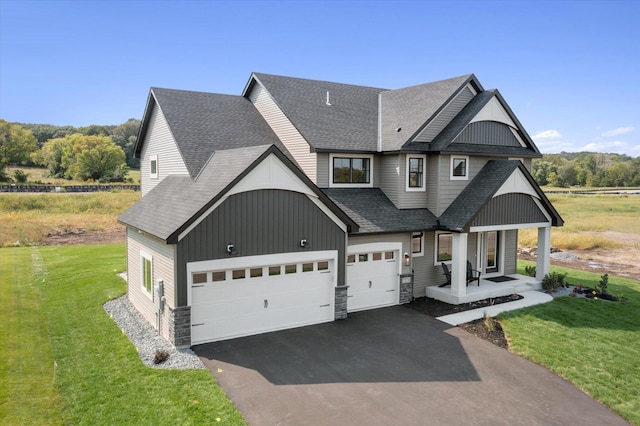 view of front facade with a porch, a garage, and a front lawn