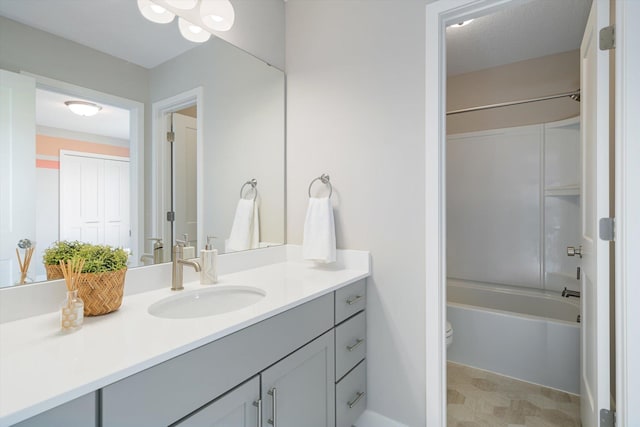 full bathroom with vanity, tub / shower combination, and toilet