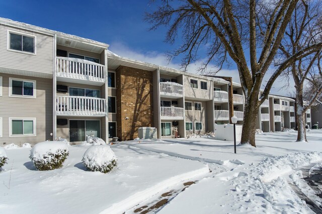 snow covered building featuring a garage