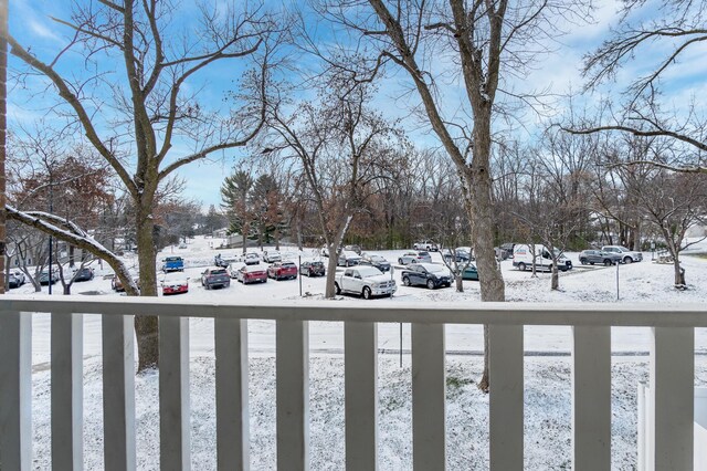 view of snow covered parking area