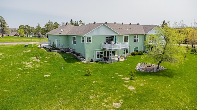 back of property with a wooden deck, a yard, and a patio area