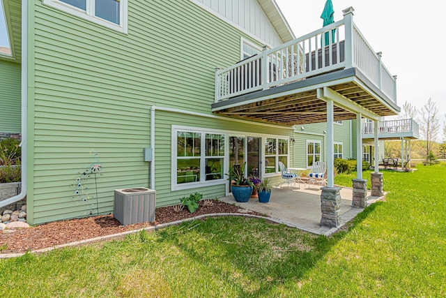 back of house featuring central AC unit, a yard, and a patio