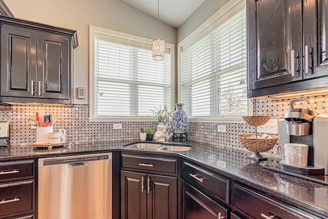 kitchen with lofted ceiling, backsplash, dark brown cabinetry, decorative light fixtures, and stainless steel dishwasher