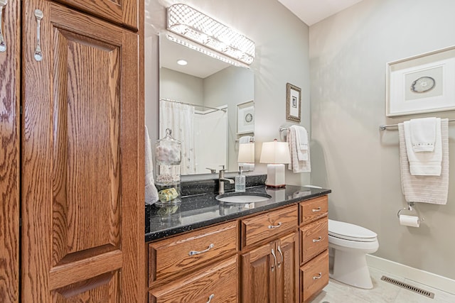 bathroom featuring walk in shower, tile patterned floors, vanity, and toilet