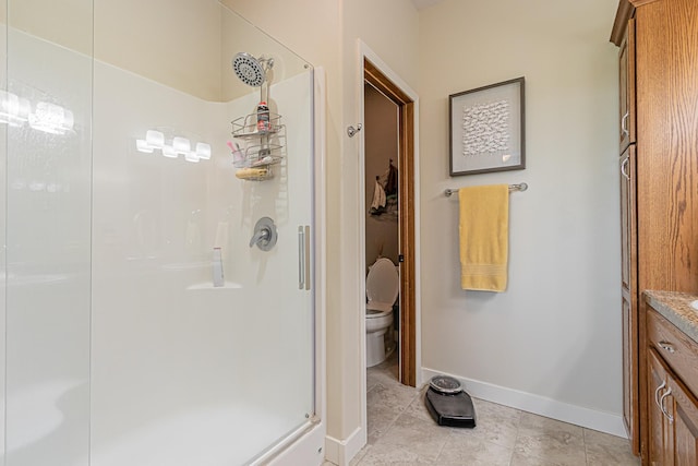 bathroom with walk in shower, tile patterned floors, and toilet