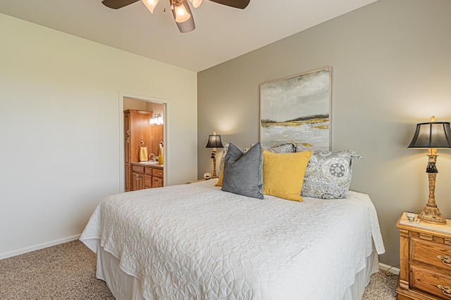 bedroom with ceiling fan, ensuite bath, and carpet