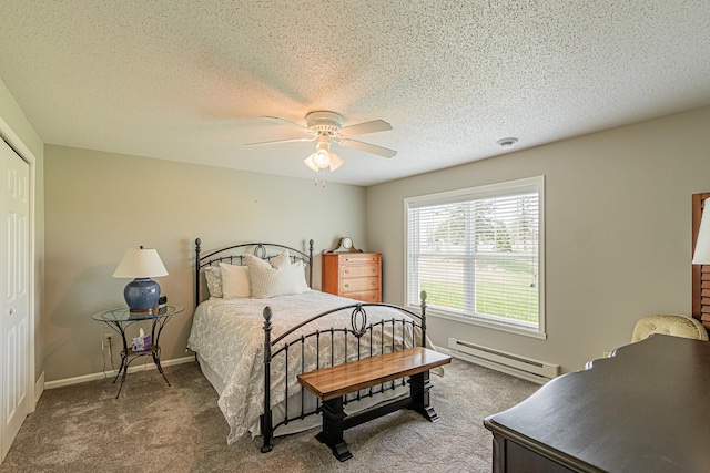 carpeted bedroom featuring a textured ceiling, a baseboard radiator, a closet, and ceiling fan