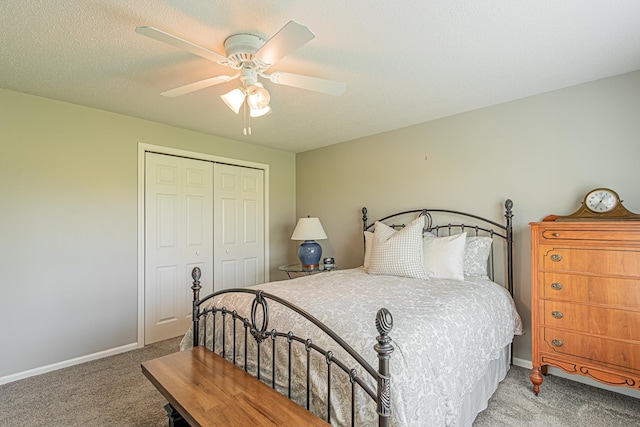 carpeted bedroom with ceiling fan, a textured ceiling, and a closet