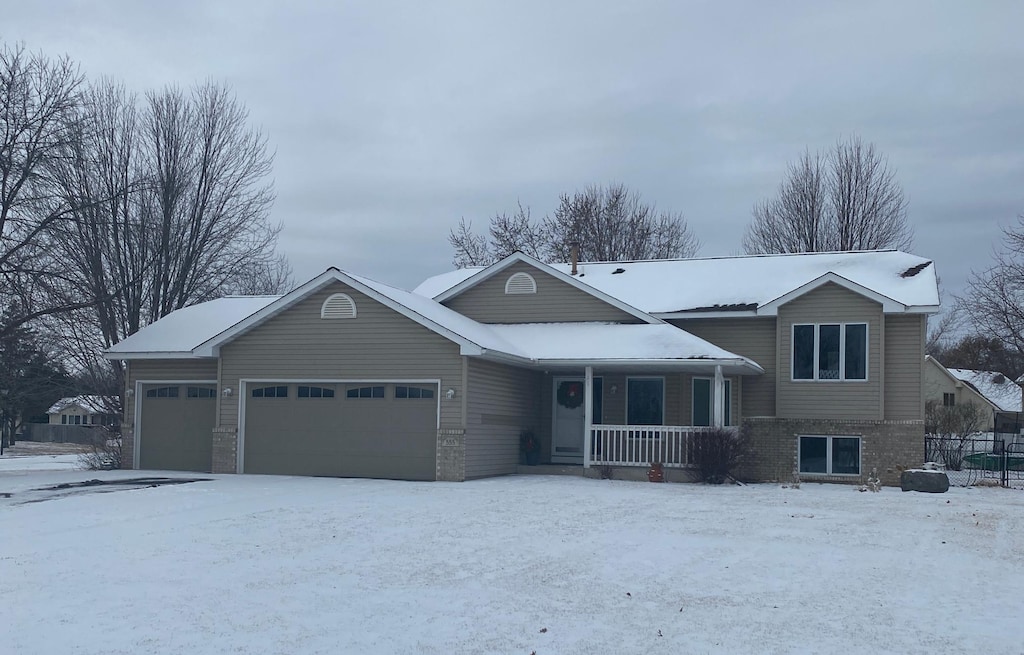 tri-level home with a garage and covered porch